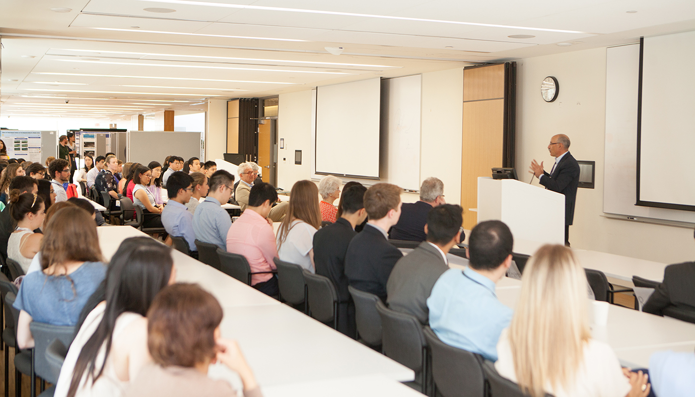 Dr. Ori Rotstein speaking to room full of researchers and students.