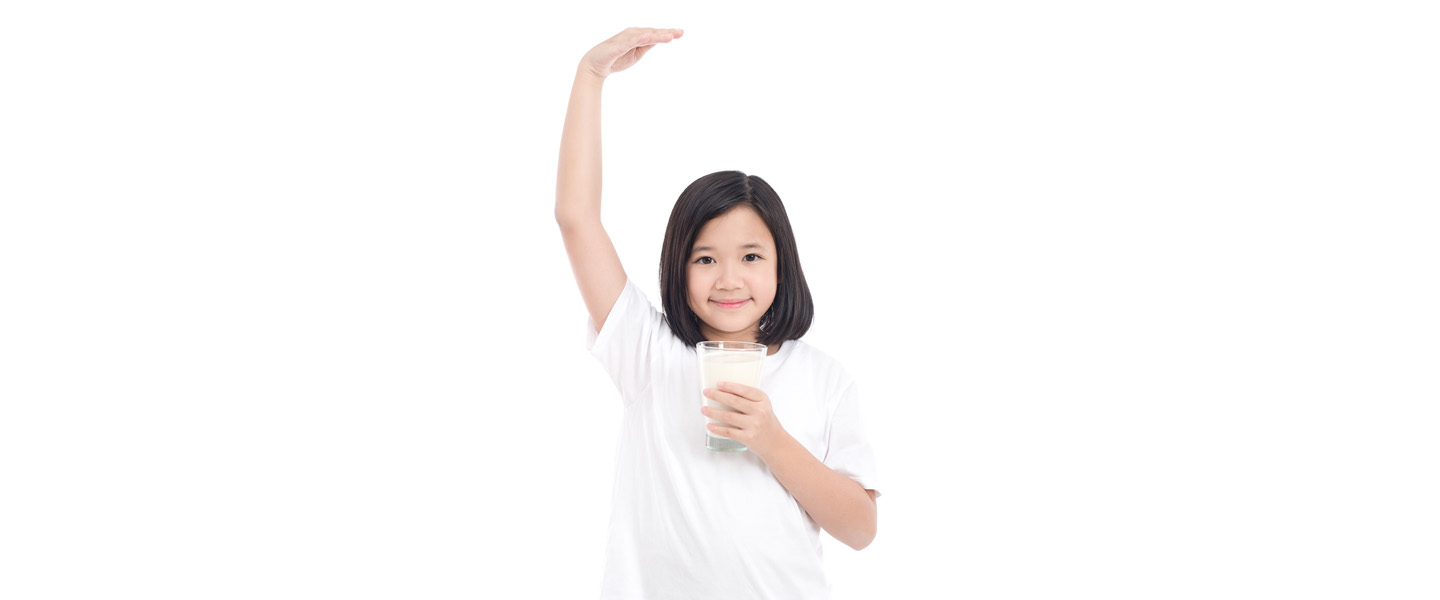 Child holding a glass of milk